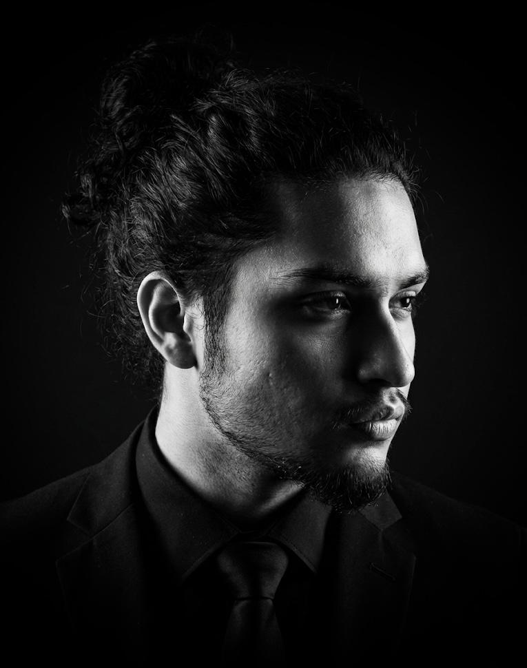 Black and white studio portrait of Moinul Khan